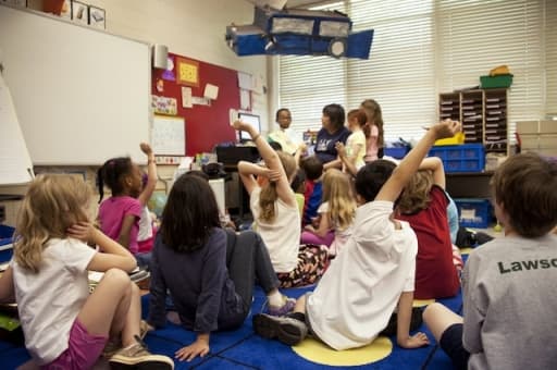 Young children sitting on a run in a classroom